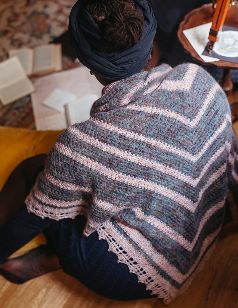 Nebular is a large triangular shawl with a fancy lace edge. There are alternating stripes of fluffy suri alpaca and merino yarn.