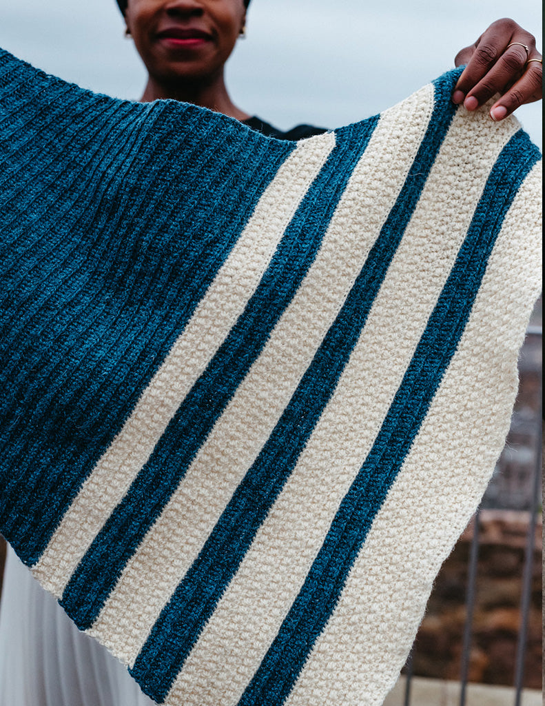 Star Trails is a small triangular shawl featuring bands of Star stitch.