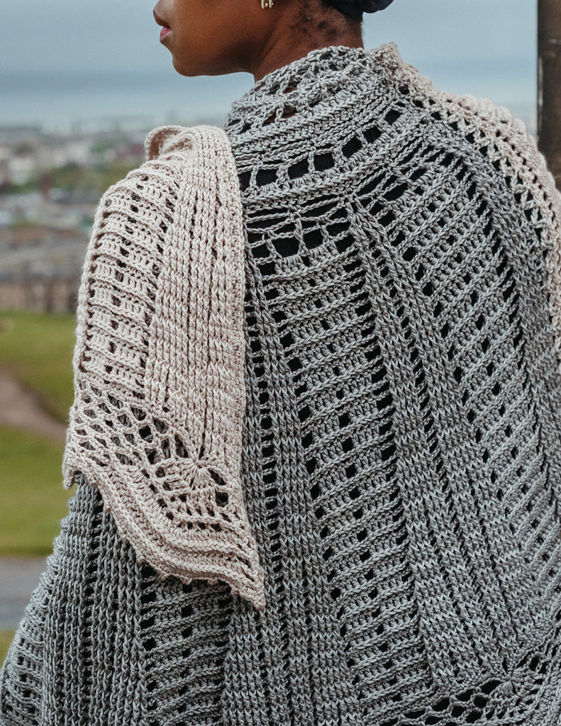 Fly Me to the Moon is a large semi-circle, two-tone shawl with lace detailing as well as post stitch sections.