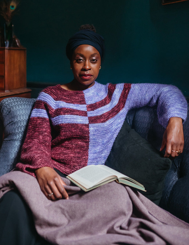 Haumea is an Aran weight jumper with gentle bell sleeves. The colour blocking divides the jumper in half, with one half dark with light stripes on the yoke, and the other side the reverse of that.