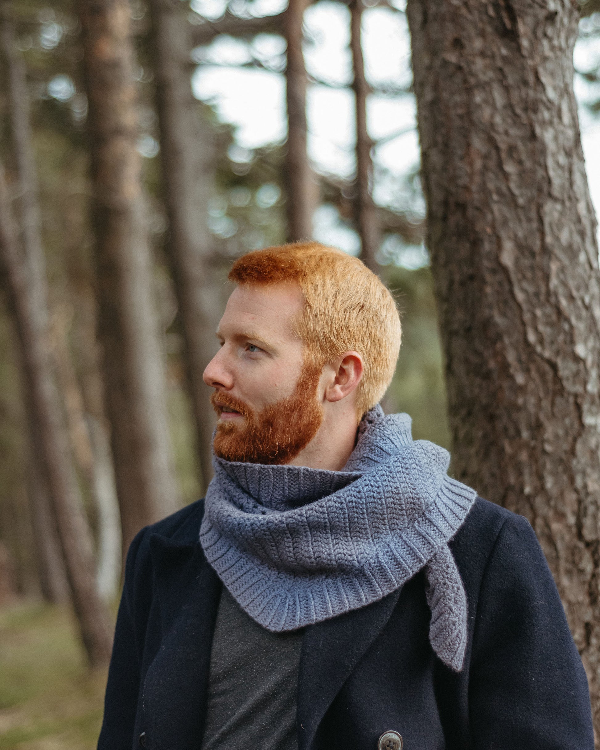 Gudrun is a shallow triangle shawl with a strip of granny stitches and a wide ribbed border.